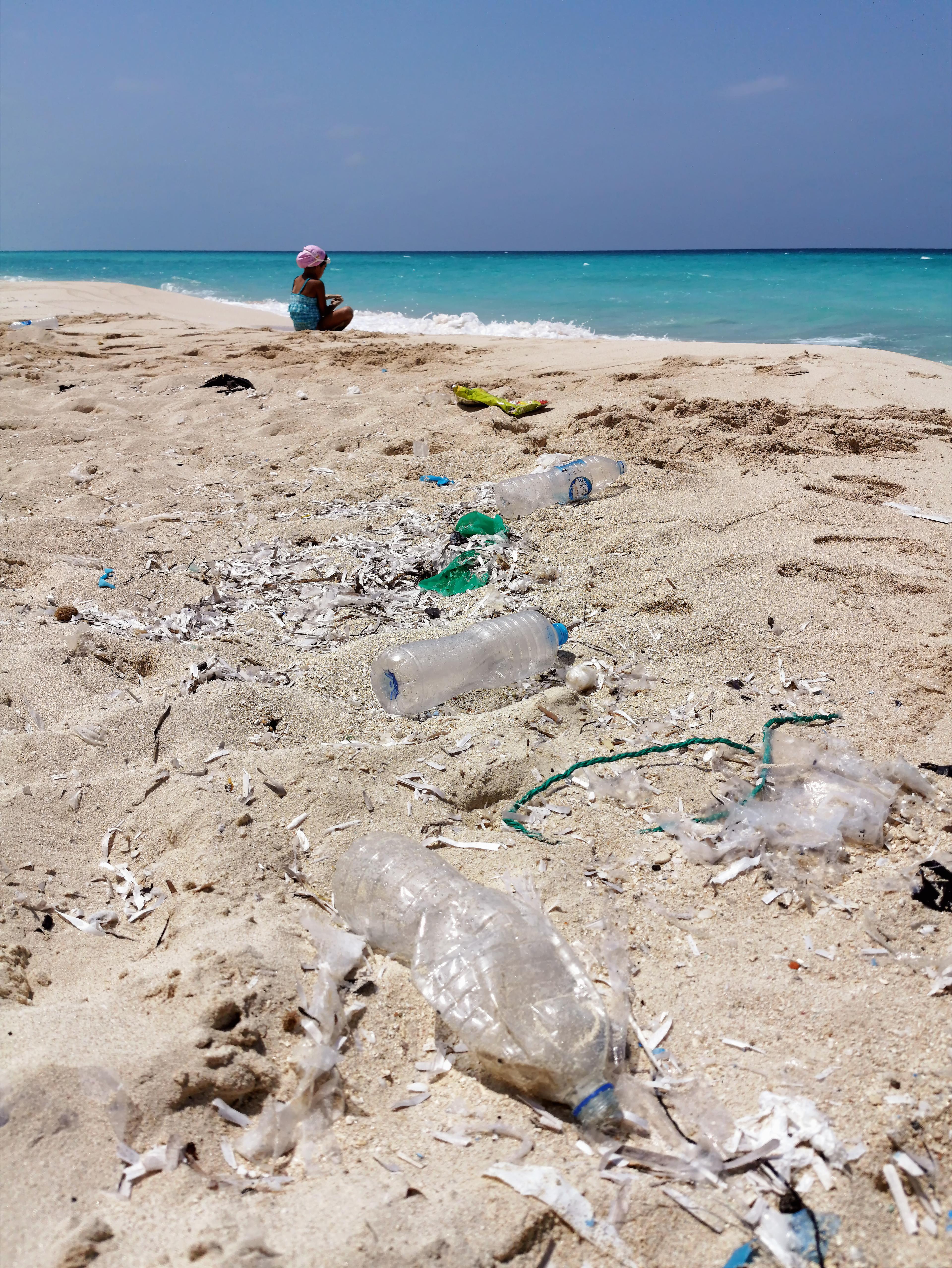 Discarded plastic on a sandy beach.
